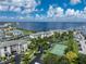 Aerial view of waterfront community with tennis courts, pool, and boat slips at 1250 W Marion Ave # 242, Punta Gorda, FL 33950
