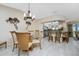Elegant dining room with glass table and wicker chairs at 1250 W Marion Ave # 242, Punta Gorda, FL 33950