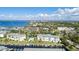 Aerial view of waterfront community with pool and tennis courts at 1250 W Marion Ave # 242, Punta Gorda, FL 33950