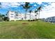 Building exterior showing manicured lawn and waterway access at 1250 W Marion Ave # 242, Punta Gorda, FL 33950