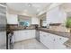 Bright kitchen with granite counters and stainless steel appliances at 1250 W Marion Ave # 242, Punta Gorda, FL 33950
