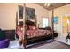 Elegant main bedroom with a four-poster bed and ensuite bathroom access at 24395 Suncoast Blvd, Punta Gorda, FL 33980