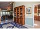 Bright dining room with a large wooden bookcase and access to the kitchen at 24395 Suncoast Blvd, Punta Gorda, FL 33980
