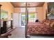 Main bedroom with a four-poster bed and access to the pool area at 24395 Suncoast Blvd, Punta Gorda, FL 33980