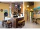 Island kitchen with granite countertops and a brick accent wall at 24395 Suncoast Blvd, Punta Gorda, FL 33980