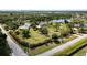 Aerial view of a yellow house on a large lot with water access at 24395 Suncoast Blvd, Punta Gorda, FL 33980