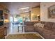 Open living room with sectional sofa and views to kitchen and dining areas at 24395 Suncoast Blvd, Punta Gorda, FL 33980