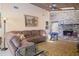 Living room with a sectional sofa, area rug, and brick fireplace at 24395 Suncoast Blvd, Punta Gorda, FL 33980
