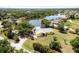 Aerial view showcasing the house and beautiful lakefront setting at 24395 Suncoast Blvd, Punta Gorda, FL 33980