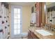 Bathroom with granite countertop, updated vanity, and private access to backyard at 24395 Suncoast Blvd, Punta Gorda, FL 33980