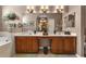Double vanity bathroom with large mirror and soaking tub at 24588 Buckingham Way, Port Charlotte, FL 33980