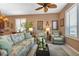 Relaxing living room featuring comfortable seating and a ceiling fan at 24588 Buckingham Way, Port Charlotte, FL 33980