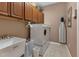Convenient laundry room with washer, dryer, cabinets, and utility sink at 24588 Buckingham Way, Port Charlotte, FL 33980