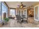 Sunroom with wicker furniture and access to the interior at 24588 Buckingham Way, Port Charlotte, FL 33980