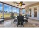 Bright sunroom, wicker furniture, and view of the golf course at 24588 Buckingham Way, Port Charlotte, FL 33980