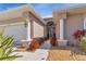 Front entryway with columns, landscaping, and a walkway at 24588 Buckingham Way, Port Charlotte, FL 33980