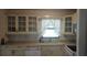 Kitchen boasts white cabinets, a window, and modern sink at 2138 Amstead St, Punta Gorda, FL 33980