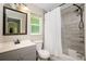 Bathroom with gray vanity, shower/tub combo and white toilet at 3159 Draper Ter, North Port, FL 34286