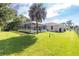 Large backyard with grassy area and screened pool at 3159 Draper Ter, North Port, FL 34286