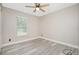 Simple bedroom with wood-look floors and a ceiling fan at 3159 Draper Ter, North Port, FL 34286