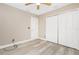 Bedroom with wood-look floors, ceiling fan, and large closet at 3159 Draper Ter, North Port, FL 34286