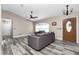 Living room with gray sofas, wood-look floors, and a view of the front door at 3159 Draper Ter, North Port, FL 34286