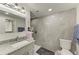 Bathroom with granite vanity, modern shower, and gray tile at 258 Shadow Nw St, Port Charlotte, FL 33952