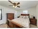 Bedroom with wooden dresser, ceiling fan, and comfortable bed at 258 Shadow Nw St, Port Charlotte, FL 33952