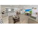 Open living room with kitchen, dining area and large TV at 258 Shadow Nw St, Port Charlotte, FL 33952