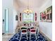 Bright dining area with a wooden table, chandelier, and view to backyard at 6568 Fairway Gardens Dr, Bradenton, FL 34203