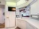 White kitchen with stainless steel appliances and an island at 6568 Fairway Gardens Dr, Bradenton, FL 34203