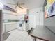 Efficient kitchen with white cabinets, tile backsplash and breakfast bar at 6568 Fairway Gardens Dr, Bradenton, FL 34203