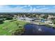 Aerial view of community clubhouse, pool, and golf course at 6568 Fairway Gardens Dr, Bradenton, FL 34203