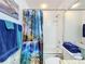 Bathroom with shower/tub combo and blue shower curtain at 6568 Fairway Gardens Dr, Bradenton, FL 34203