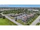 An aerial view of condos with parking, landscape, and a pool on a sunny day at 1001 W Marion Ave # 14, Punta Gorda, FL 33950