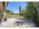 The backyard features a small brick patio, views of green space, and rock landscaping at 1001 W Marion Ave # 14, Punta Gorda, FL 33950