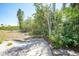 This backyard has a small brick patio and views of lush tropical foliage at 1001 W Marion Ave # 14, Punta Gorda, FL 33950