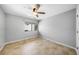 Cozy bedroom with neutral paint, tile flooring, and a bright window at 1001 W Marion Ave # 14, Punta Gorda, FL 33950