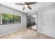 This bedroom offers tile flooring, and sliding glass doors leading into an enclosed porch at 1001 W Marion Ave # 14, Punta Gorda, FL 33950
