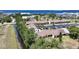 An exterior view of a row of condos with red tile roofs, parking, and nearby waterfront views at 1001 W Marion Ave # 14, Punta Gorda, FL 33950