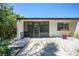 View of the rear exterior of the property, with a screened-in porch and rock landscaping at 1001 W Marion Ave # 14, Punta Gorda, FL 33950
