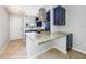 Modern kitchen featuring stainless steel appliances, granite countertops, and custom blue cabinetry at 1001 W Marion Ave # 14, Punta Gorda, FL 33950
