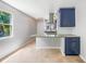 Eat-in kitchen features blue cabinets, granite countertops, modern appliances, and a window over the sink at 1001 W Marion Ave # 14, Punta Gorda, FL 33950