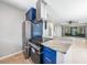 Modern kitchen featuring stainless steel appliances, granite countertops, and custom blue cabinetry at 1001 W Marion Ave # 14, Punta Gorda, FL 33950