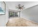 Bright living room featuring a ceiling fan, neutral paint, and sliding glass doors to screened-in porch at 1001 W Marion Ave # 14, Punta Gorda, FL 33950