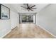 Bright living room with tile flooring, neutral walls, and sliding glass doors leading to a screened-in patio at 1001 W Marion Ave # 14, Punta Gorda, FL 33950