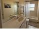 This bathroom features a large mirror, tub and shower combination, and white vanity with ample counter space at 269 Rosemary St, Port Charlotte, FL 33954
