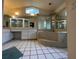 Bathroom featuring a bathtub, large mirrors, a window, tile flooring, and a sink at 269 Rosemary St, Port Charlotte, FL 33954