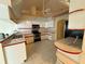 Well-lit kitchen featuring tiled flooring, stainless steel appliances, and plentiful counter space at 269 Rosemary St, Port Charlotte, FL 33954