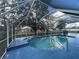 Screened-in pool with blue tiled deck, perfect for relaxation at 269 Rosemary St, Port Charlotte, FL 33954